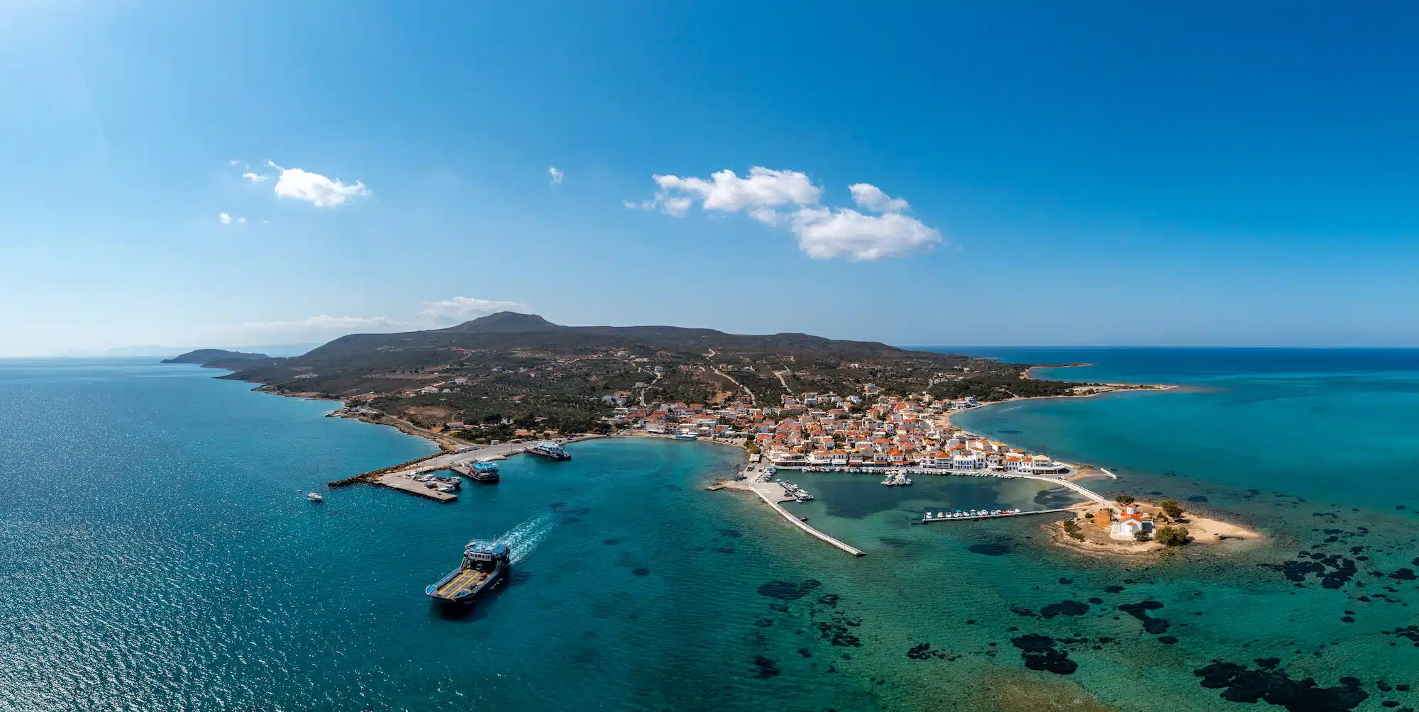 Elafonisos Peloponnese. Greece. Ferry departing from harbor to Pounta Lakonia, aerial drone view,